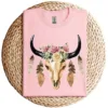 17-1-2.webp Cow Skull with Feathers and Pink Roses T-Shirt – Boho Western Floral Graphic Tee – Country Cowgirl Shirt for Women