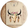 17-4-2.webp Cow Skull with Feathers and Pink Roses T-Shirt – Boho Western Floral Graphic Tee – Country Cowgirl Shirt for Women