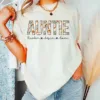 Personalized-Auntie-With-Kids-Name-Shirt-1.webp Personalized Auntie With Kids Name Shirt, Aunt Mothers Day Gift, Vintage Auntie Name Shirt, Mothers Day Gift For Auntie, Auntie Floral Shirt