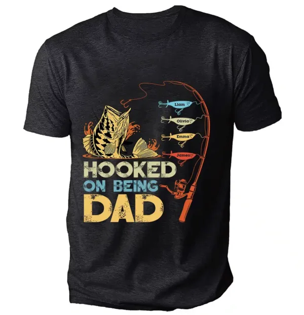 Personalized-Hooked-On-Being-Dad-Fishing-Shirts-4.webp Personalized Hooked On Being Dad Fishing Shirts, Vintage Dad Shirt, Best Dad T-Shirt, Funny Fishing Shirts For Men, Gifts For Fisherman